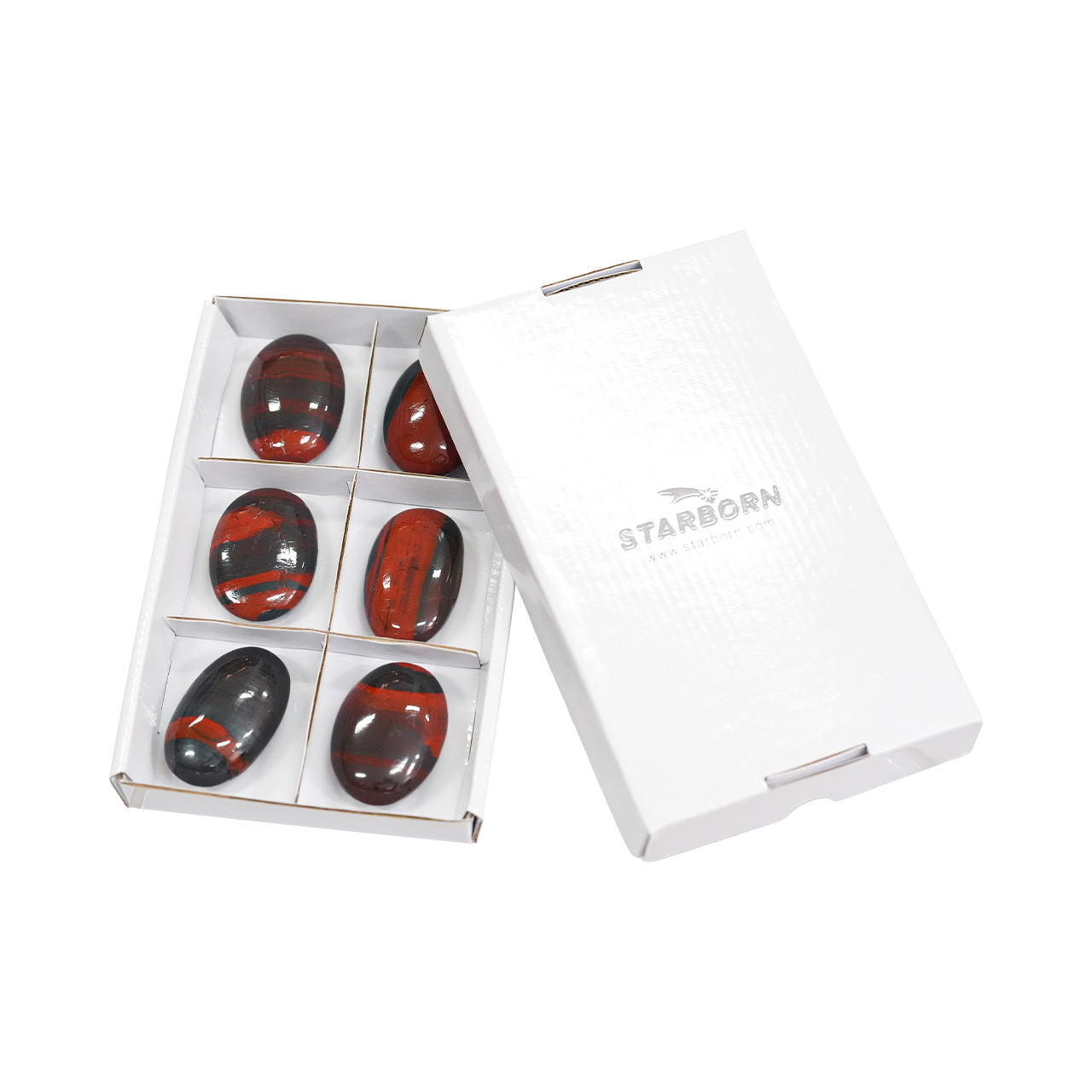 Angled view of six Ancestralite palm stones shown with the protective storage box.