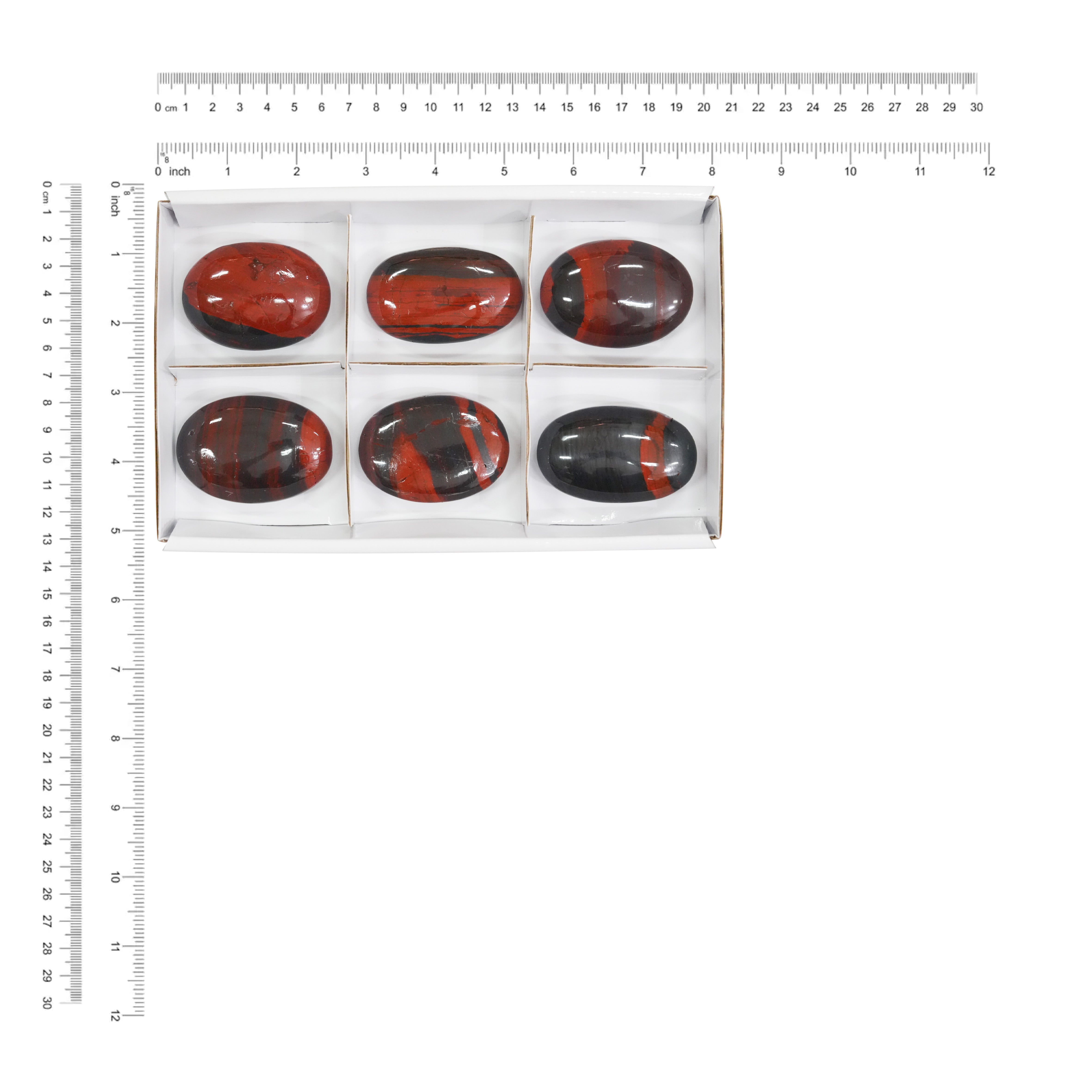 Six Ancestralite palm stones displayed next to a measurement chart showing the height and width in centimeters and inches.