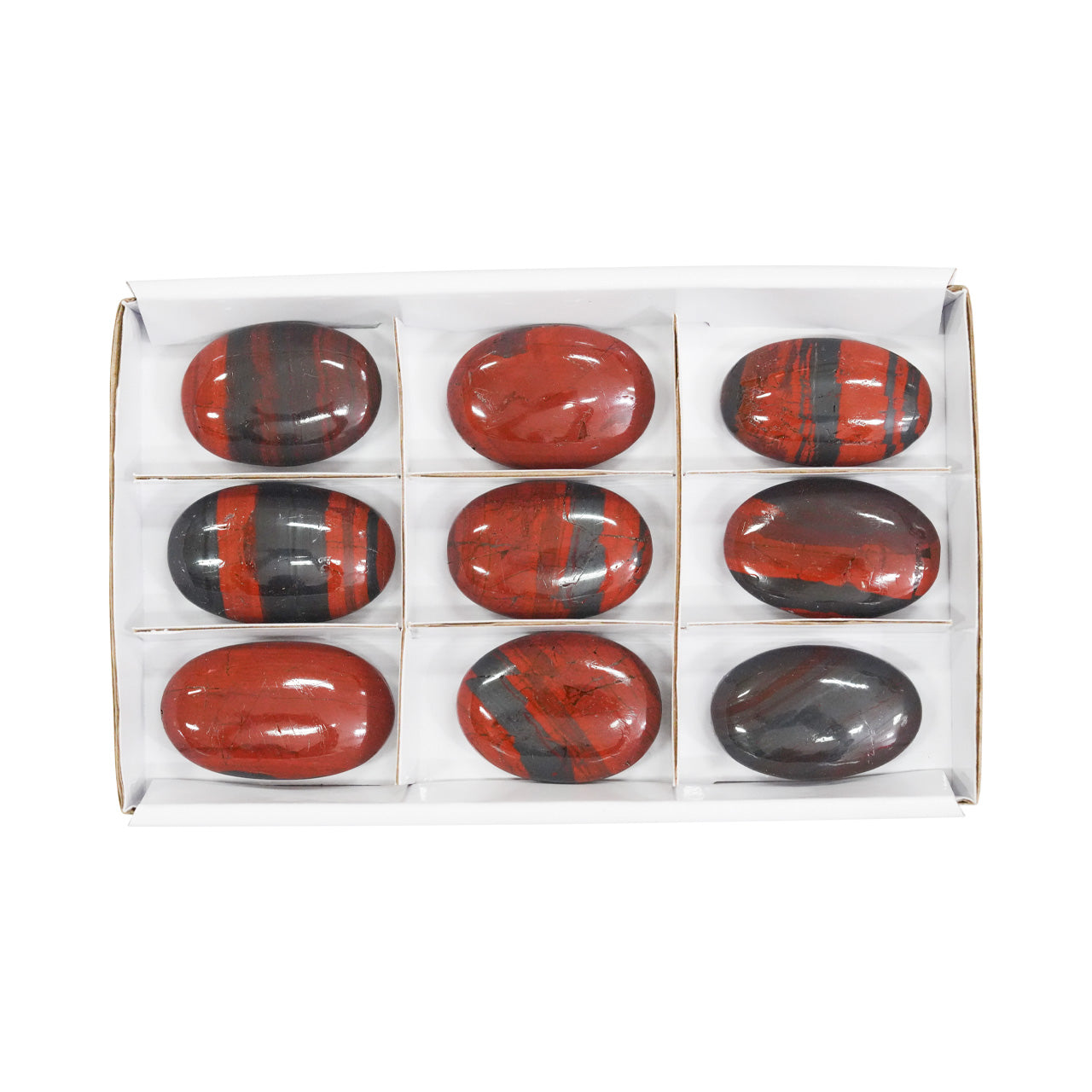 Front view of nine Ancestralite palm stones showing the natural red and dark gray banding.