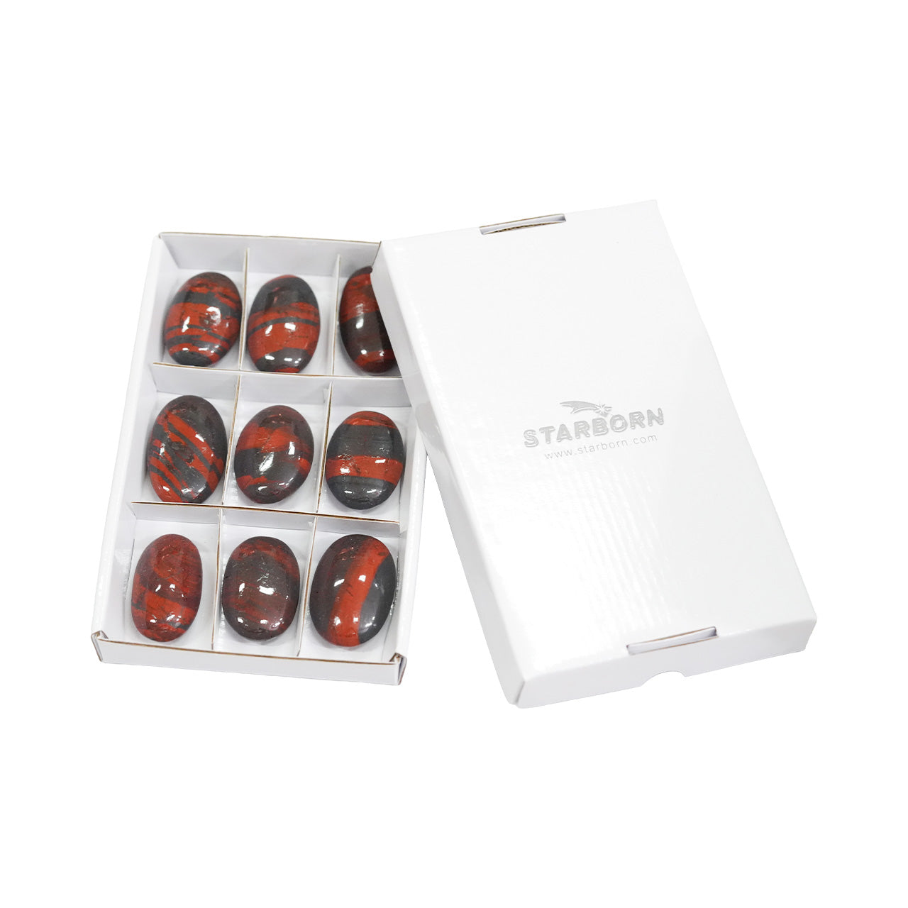 Angled view of nine Ancestralite freeform palm stones shown with the protective storage box.