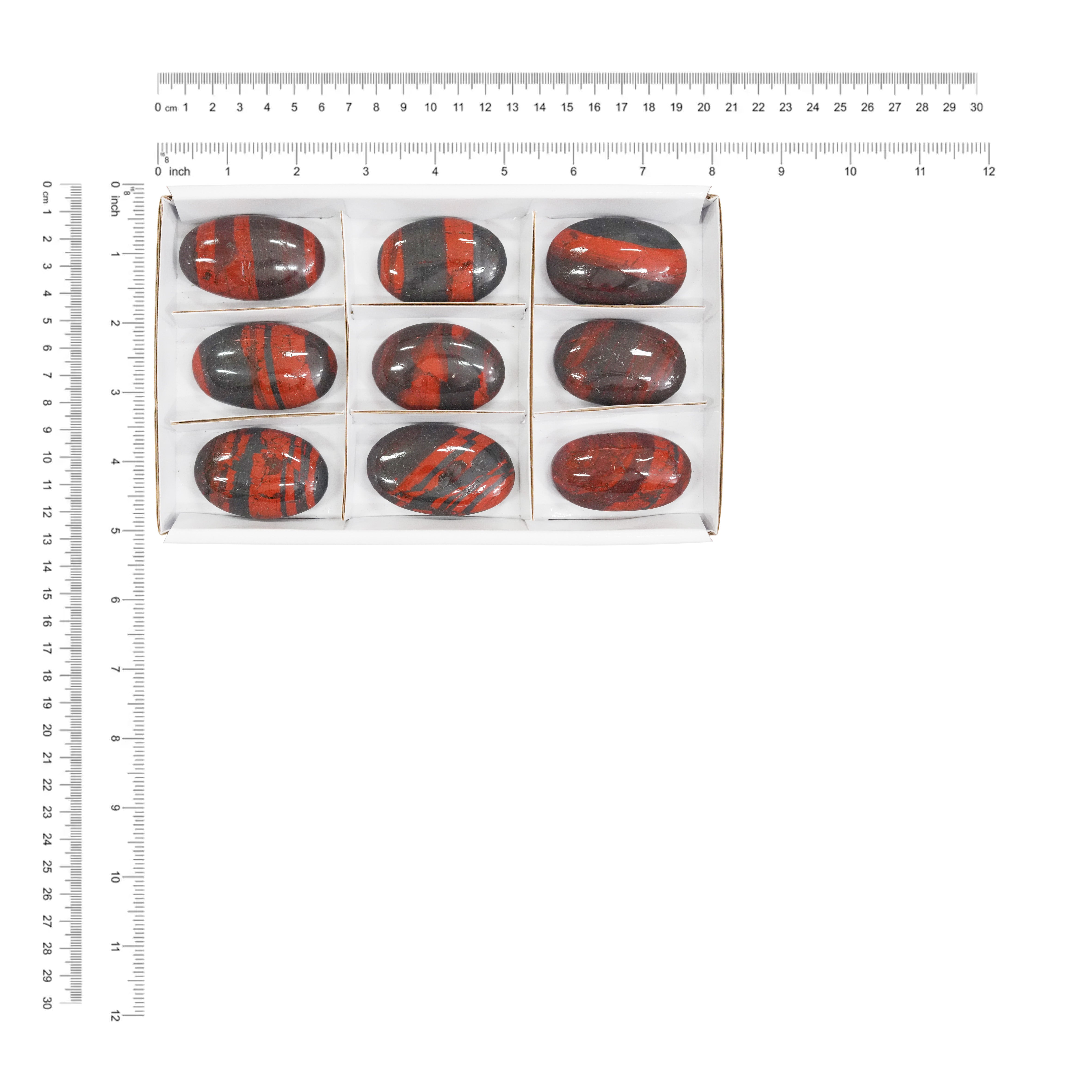 Nine Ancestralite oval palm stones displayed next to a measurement chart showing the height and width in centimeters and inches.