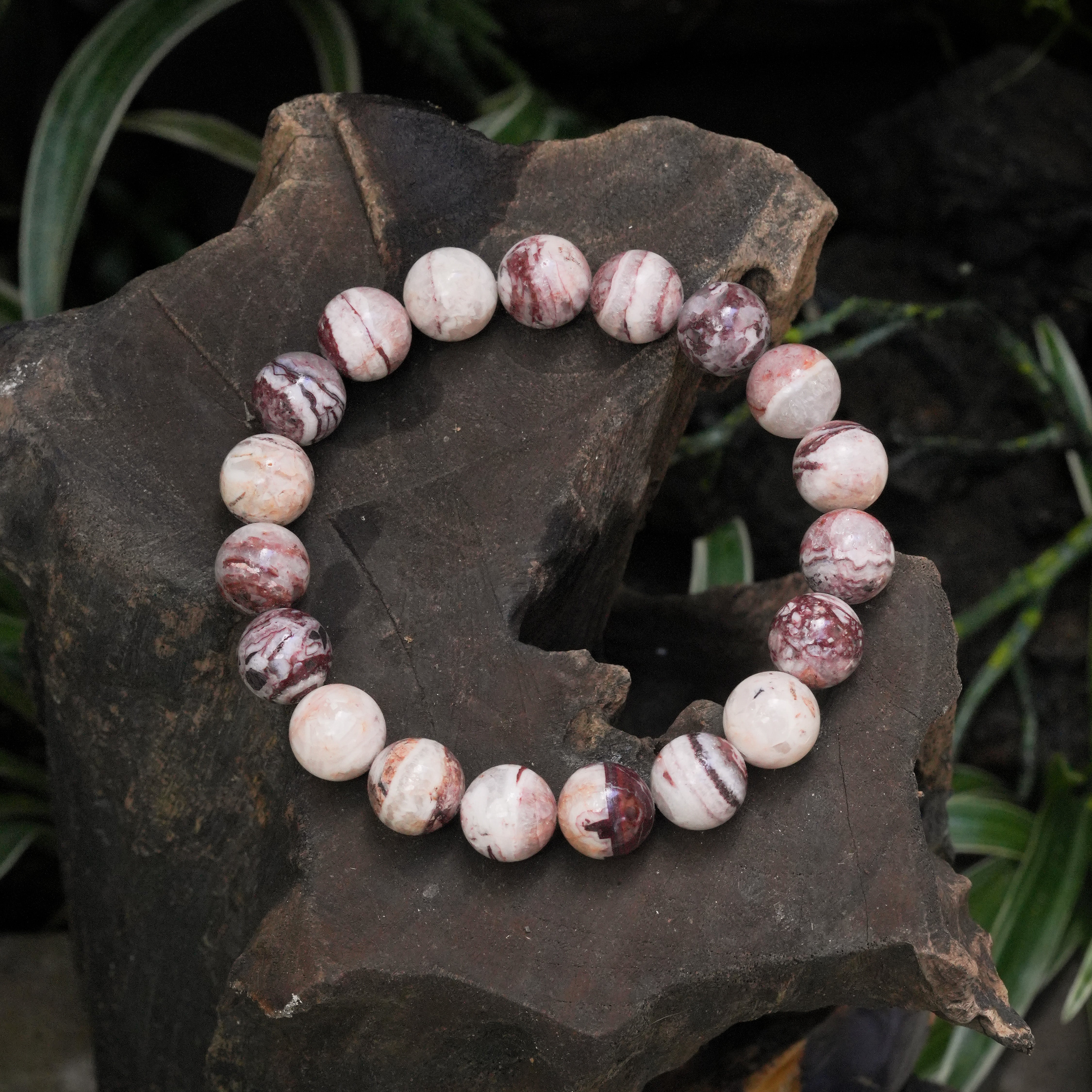 Alternate front view of a round Arizona Agate Mountain bead bracelet showing polished beads with natural grey, white, and reddish-brown banding.