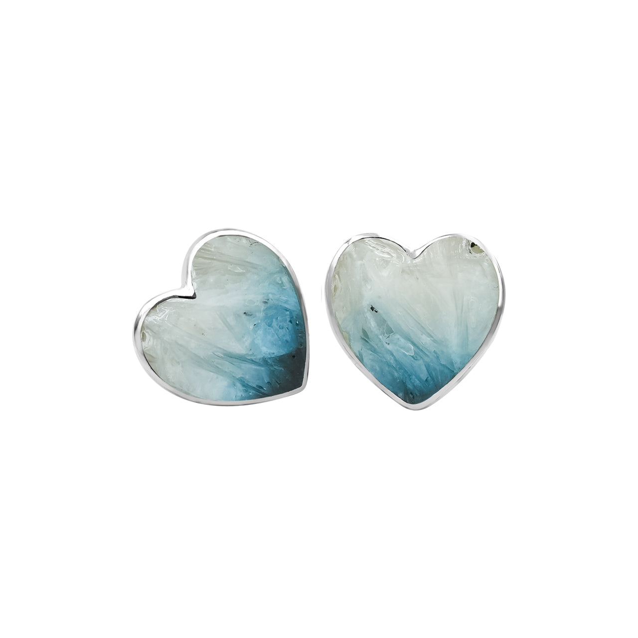 Front‑view image of a pair of heart‑shaped Blue Ice Glacierite stud earrings, showing smooth polished heart faces with blue and dark blue stone patterning set in silver. Showcasing variations.