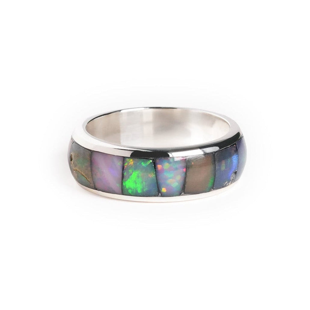 Alternate front view of a channel ring with Ethiopian opal inlay showing green, blue, and pink play‑of‑color.