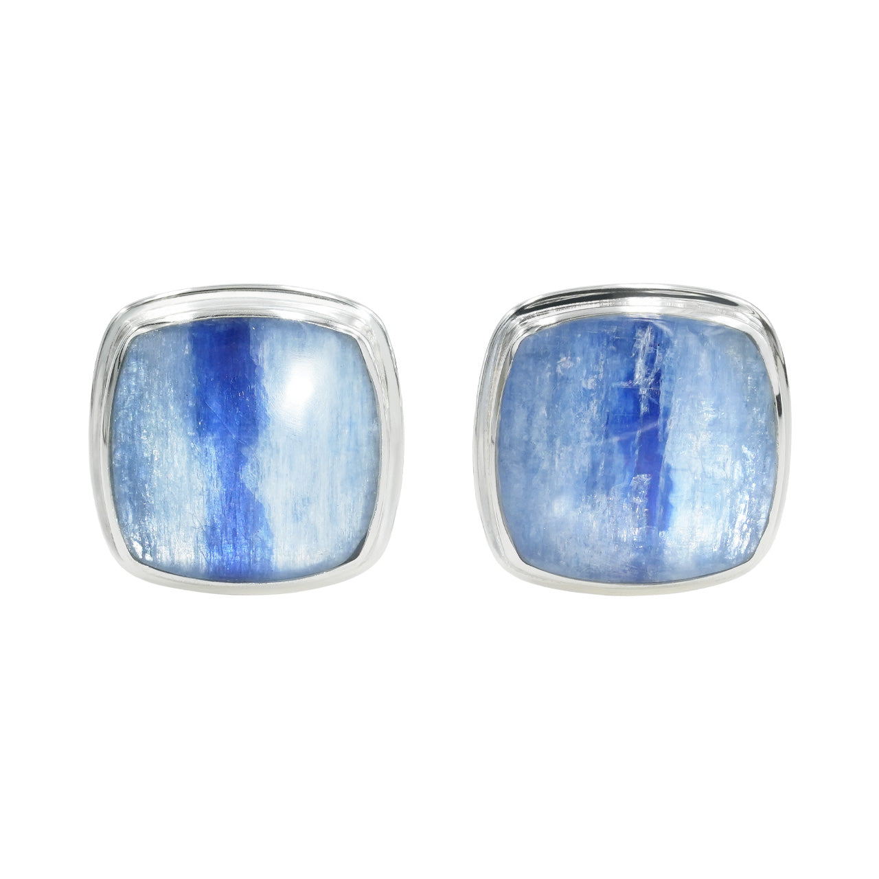 Pair of kyanite cufflinks placed upright on a surface, showing the square blue stones from a slightly angled front perspective.
