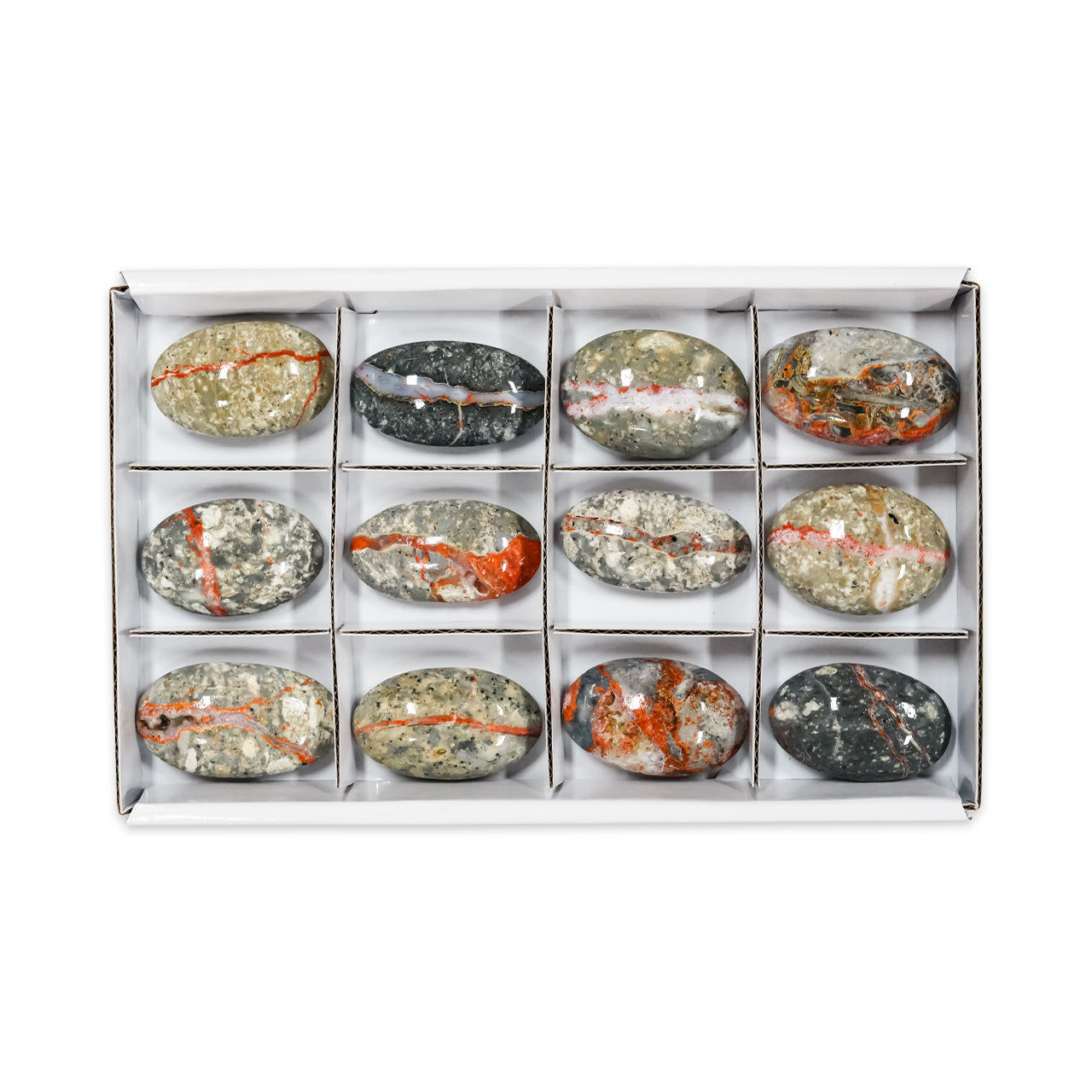 Front-facing view of the same set of oval magma chalcedony palm stones displayed inside a sturdy flat box with sections, showing each stone placed in separate compartments with varied natural color patterns and marbling.