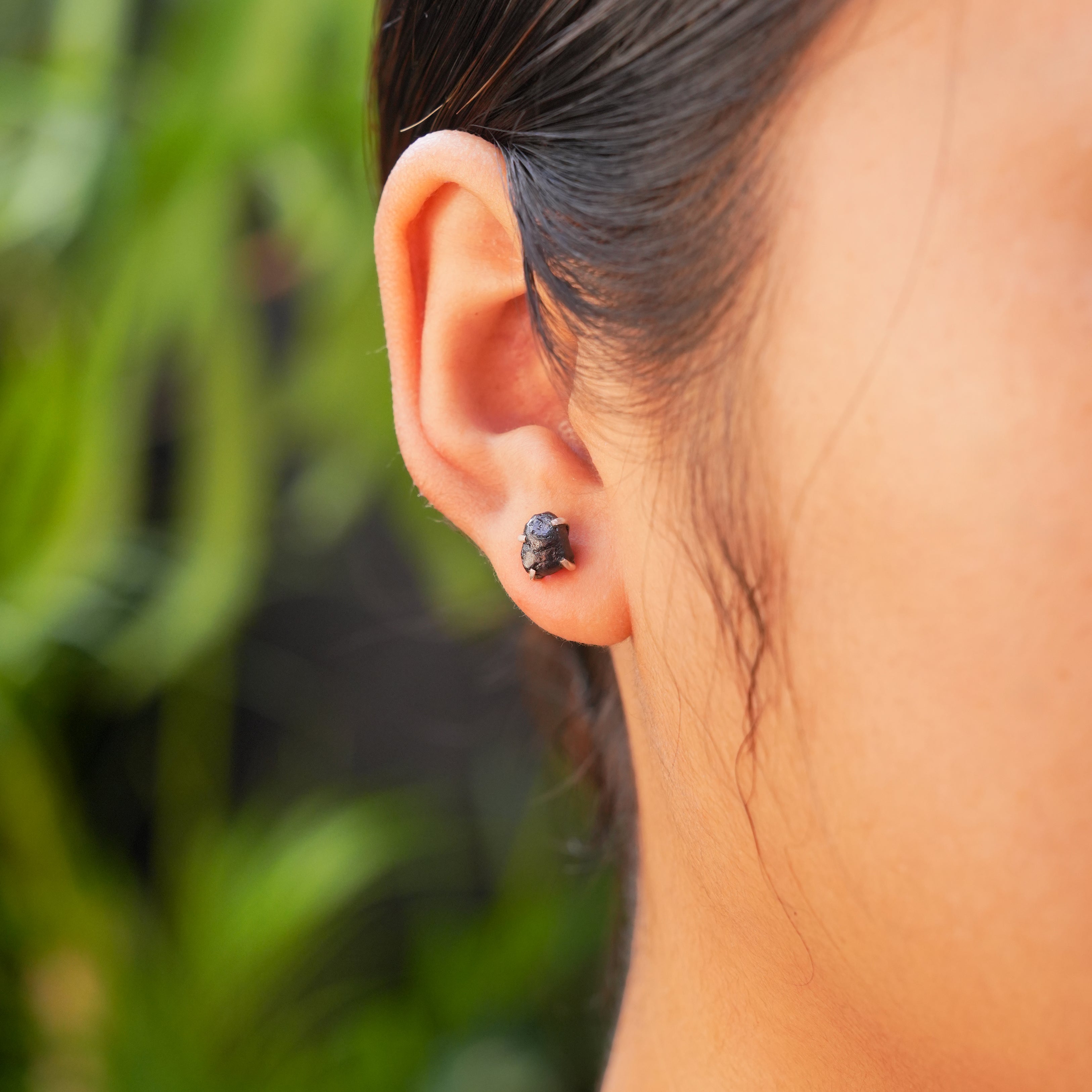 Agoudal Iron Meteorite prong set post earring worn on ear for size reference.