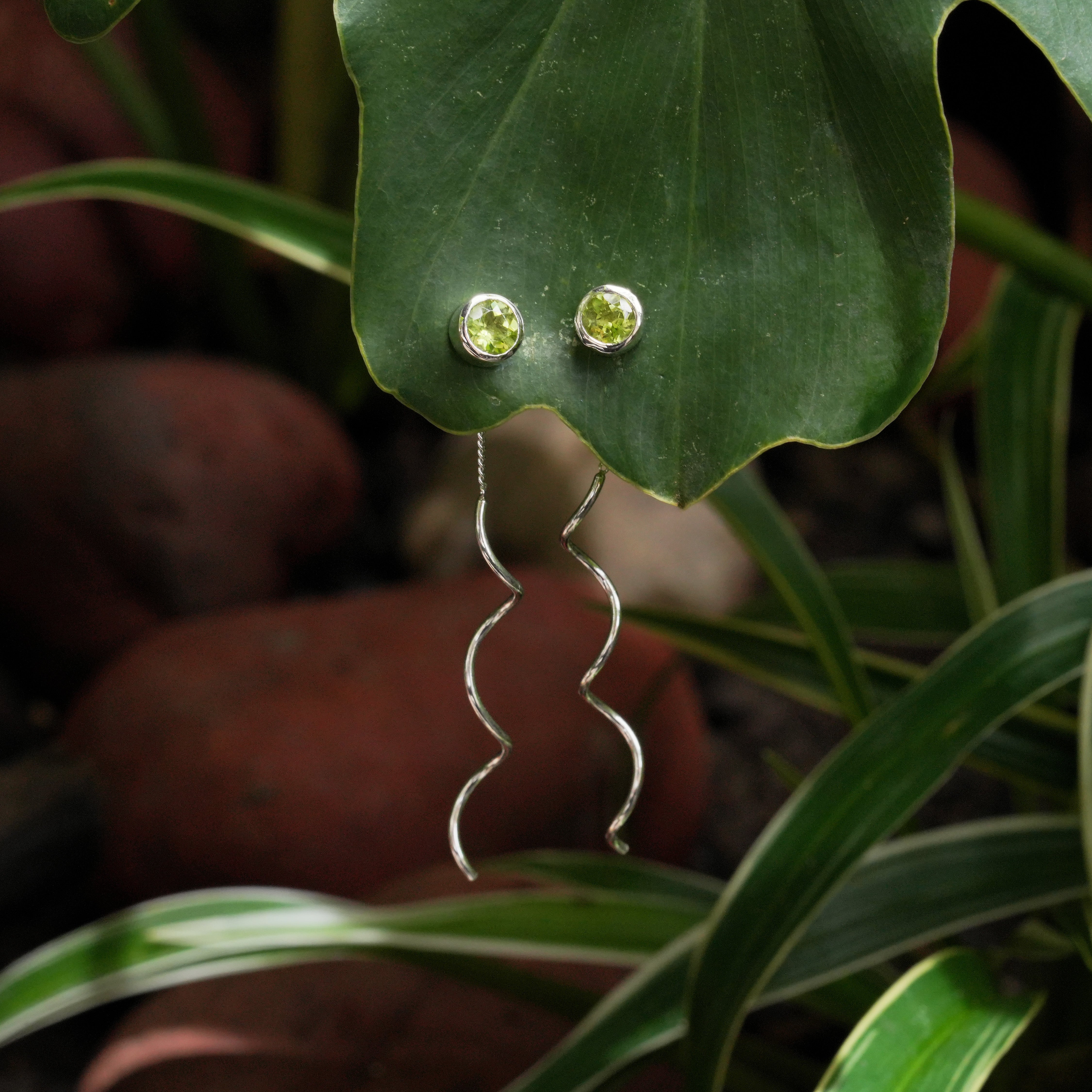 Starborn Faceted Peridot Stud Earrings with Flowing Curled Wire Drop in Sterling Silver