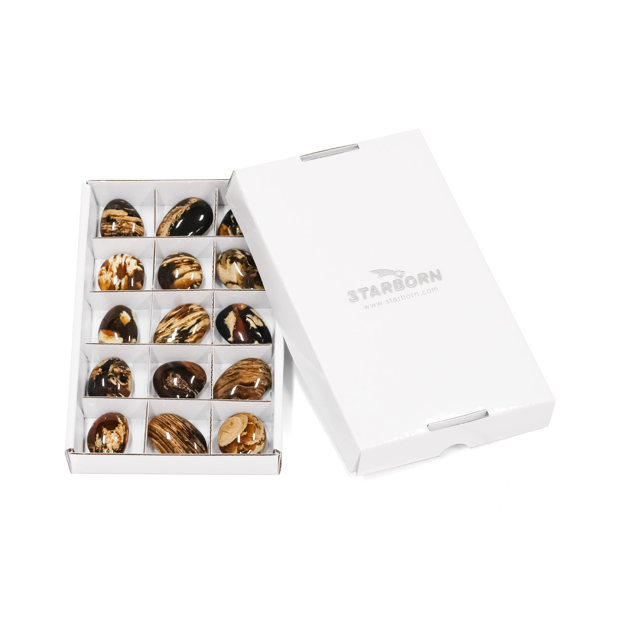 Boxed set of 15 pcs Milk & Honey Sumatra amber freeform palm stones arranged in a white box with dividers beside a closed white lid.