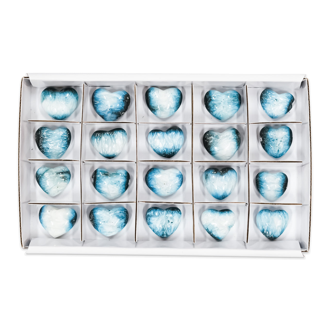 Second front‑view image of multiple polished heart‑shaped Blue Ice Glacierite stones arranged in a sturdy flat box with sections, showing smooth heart forms with blue and dark blue internal patterning. Showcasing variations.