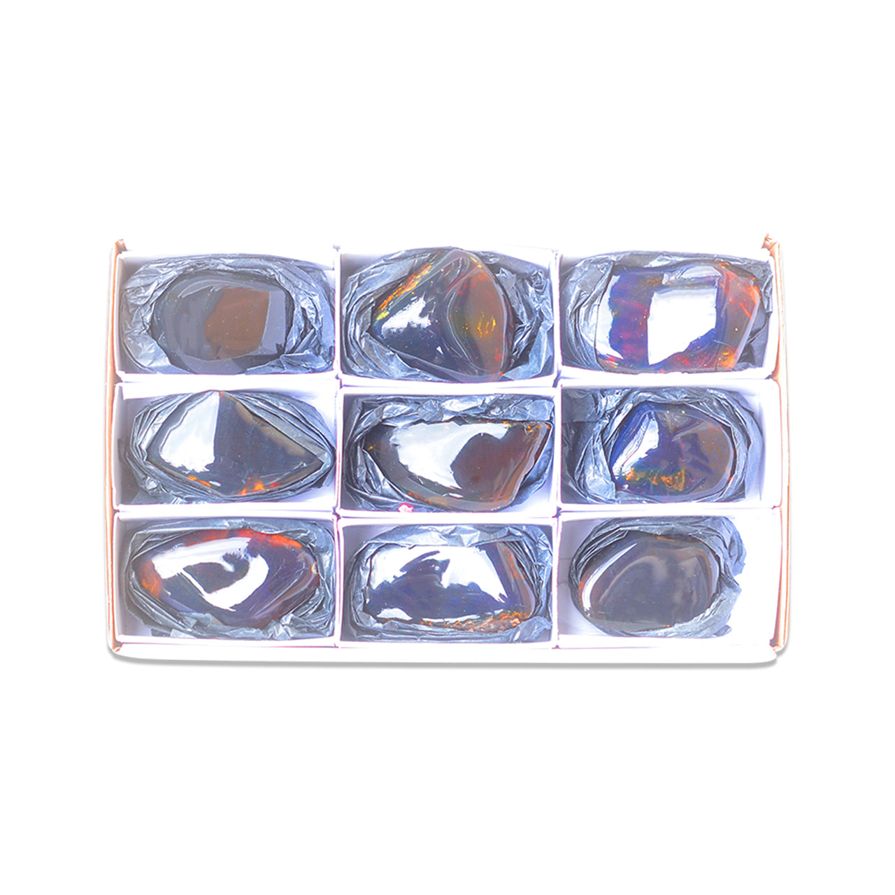 Third front view of nine polished Sumatra Blue Amber collector pieces arranged in a white box with dividers.
