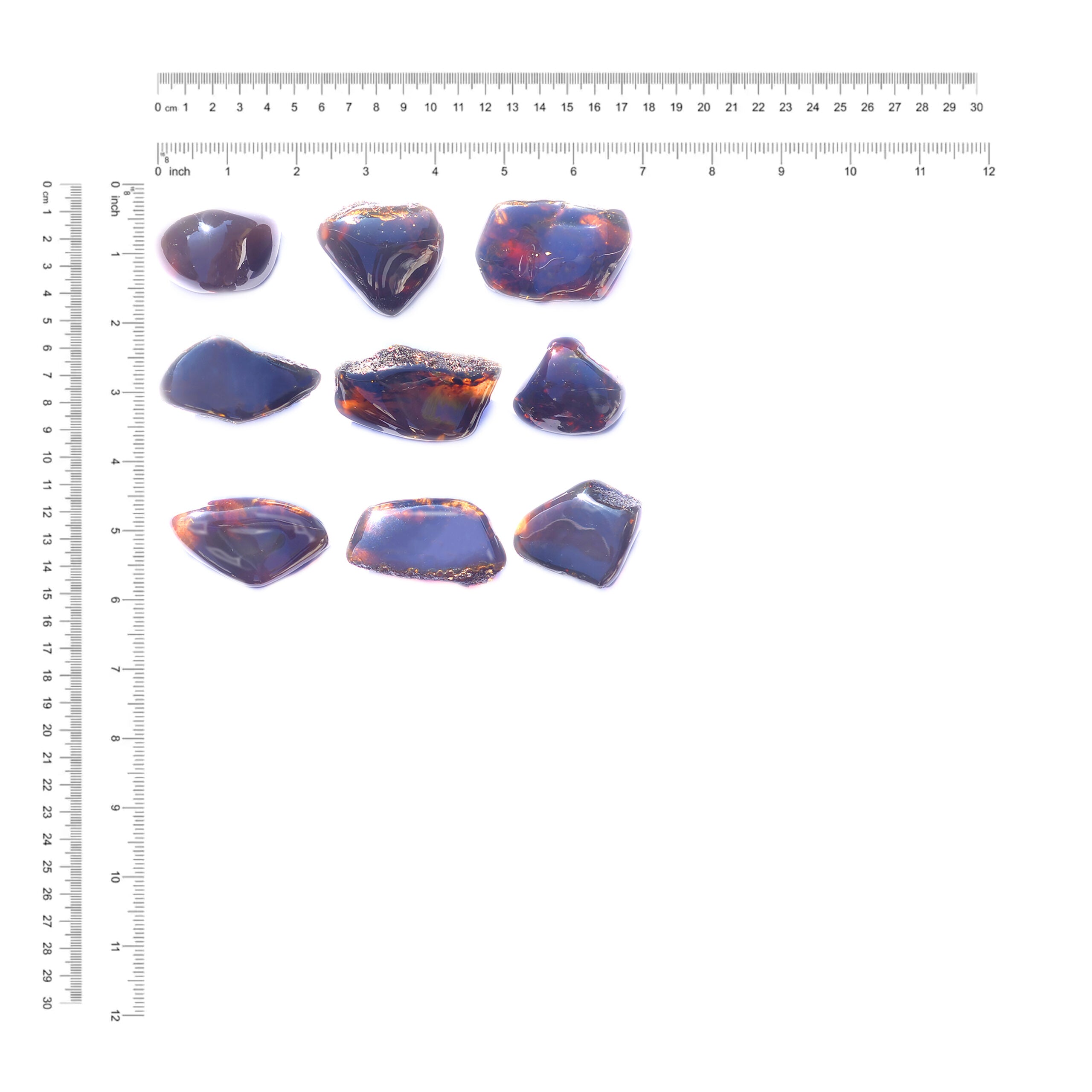 9pcs of Sumatra Blue Amber collector pieces shown next to a measurement chart displaying the dimensions in inches and centimeters