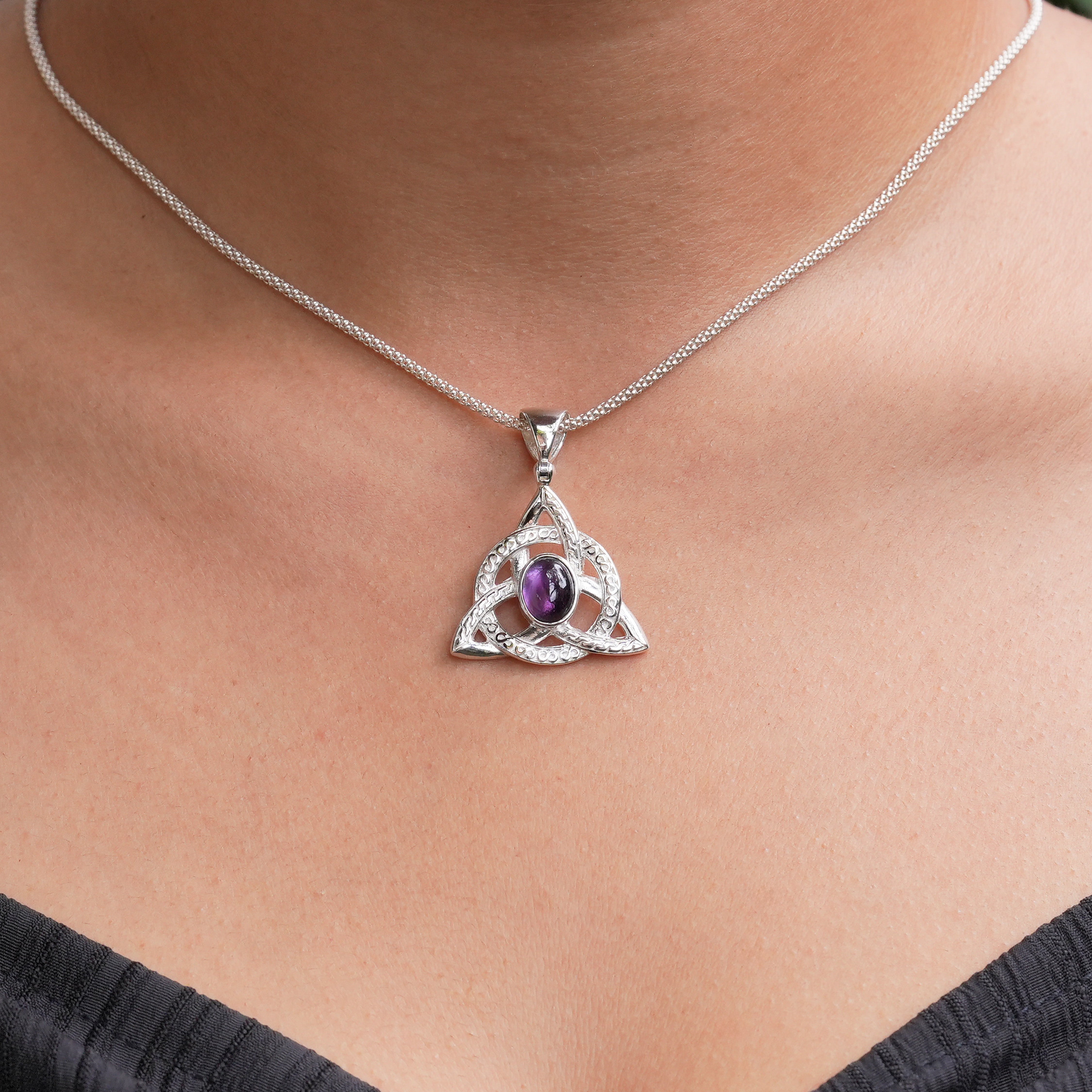 Amethyst triquetra pendant necklace shown on a model outline for size reference.