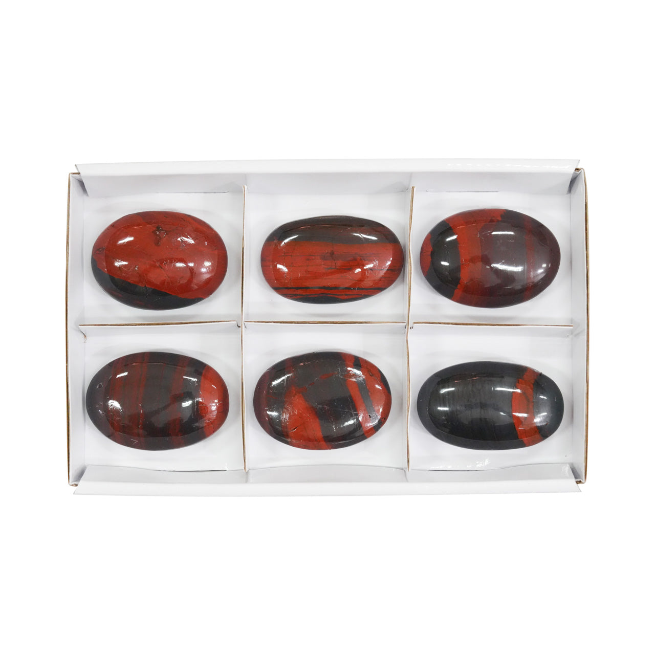 Front view of six Ancestralite palm stones showing the natural red and dark grey banding.