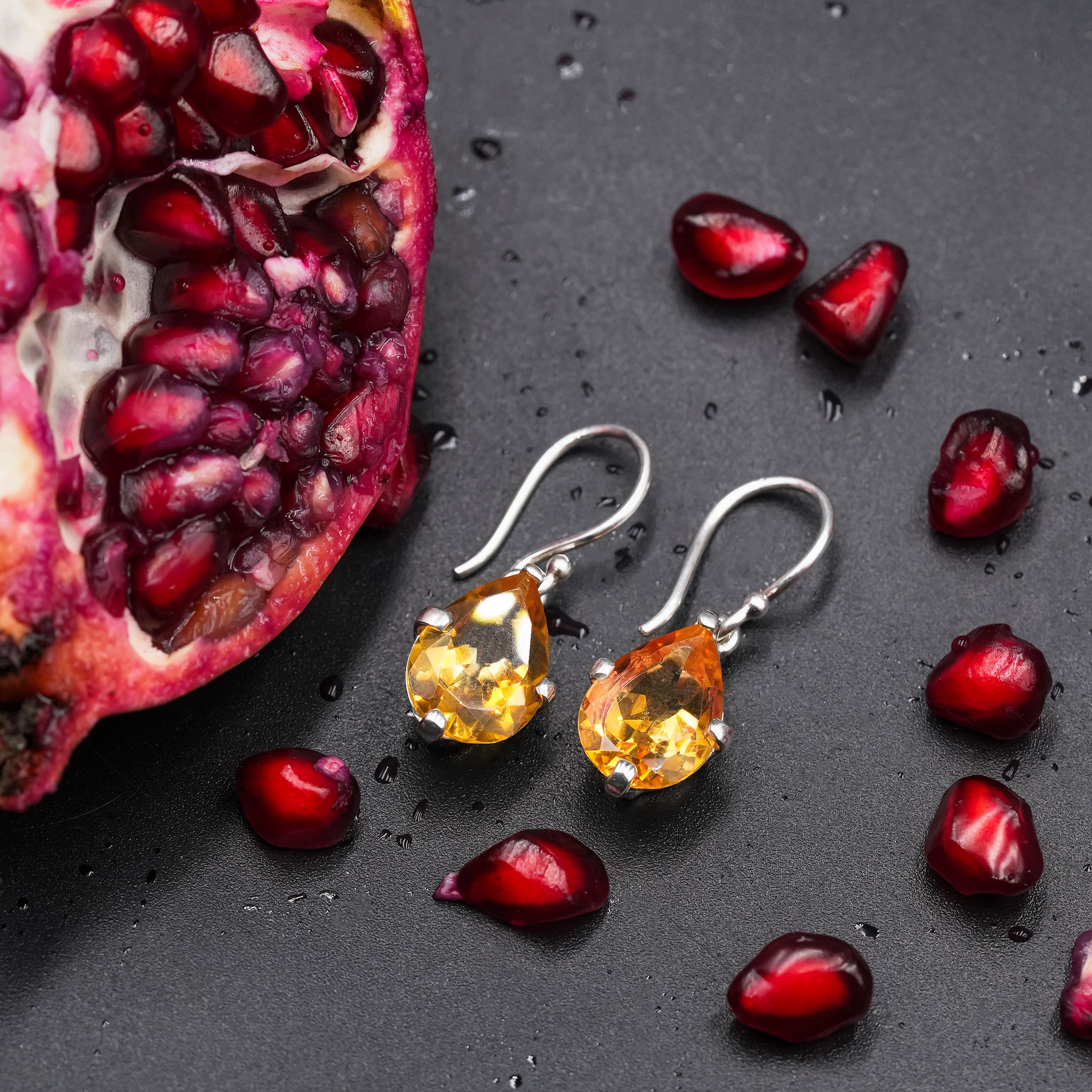Alternate angled view of pear faceted Citrine dangle earrings showing the sterling silver hooks.