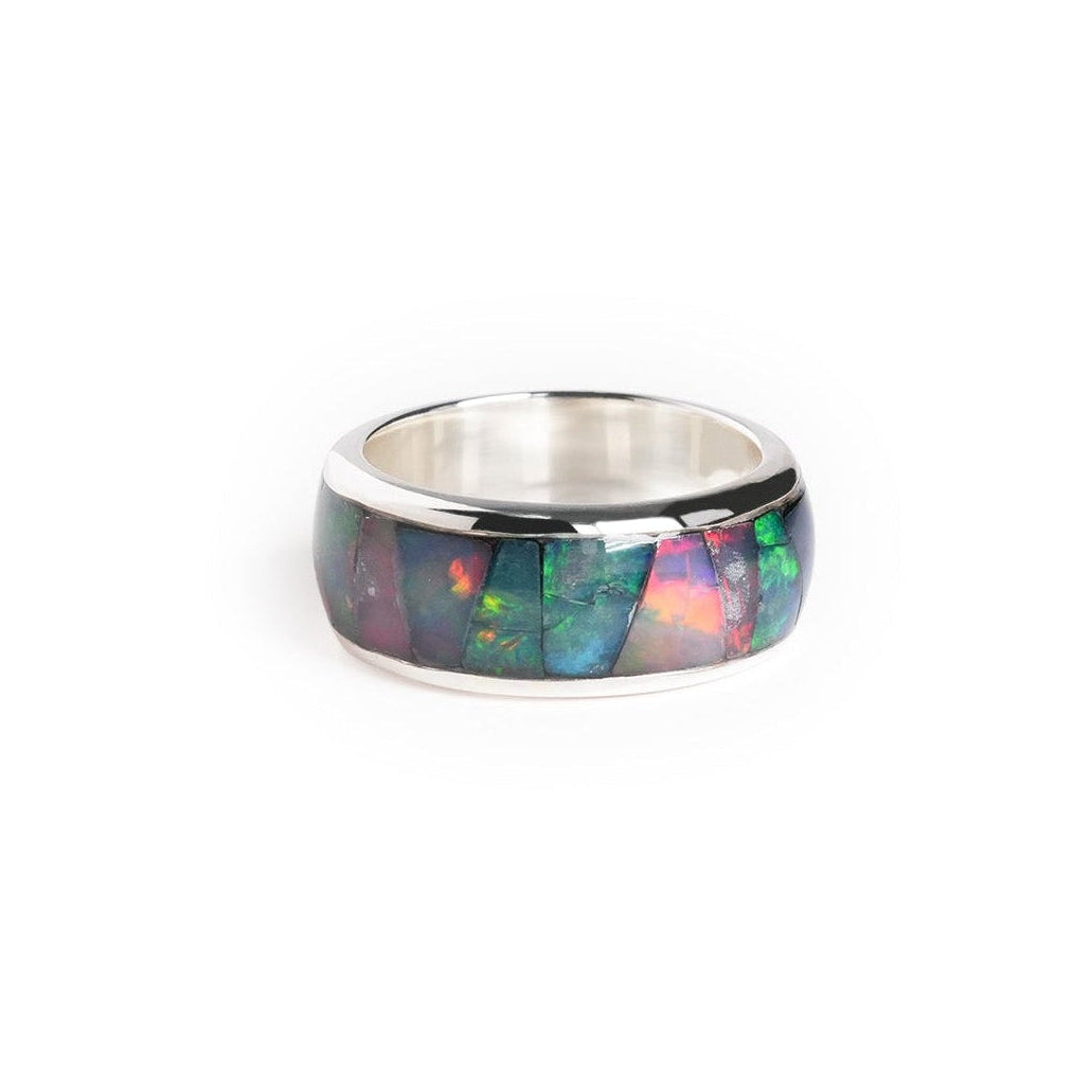 Front view of a channel ring with Ethiopian opal inlay showing green, blue, and pink play‑of‑color.


