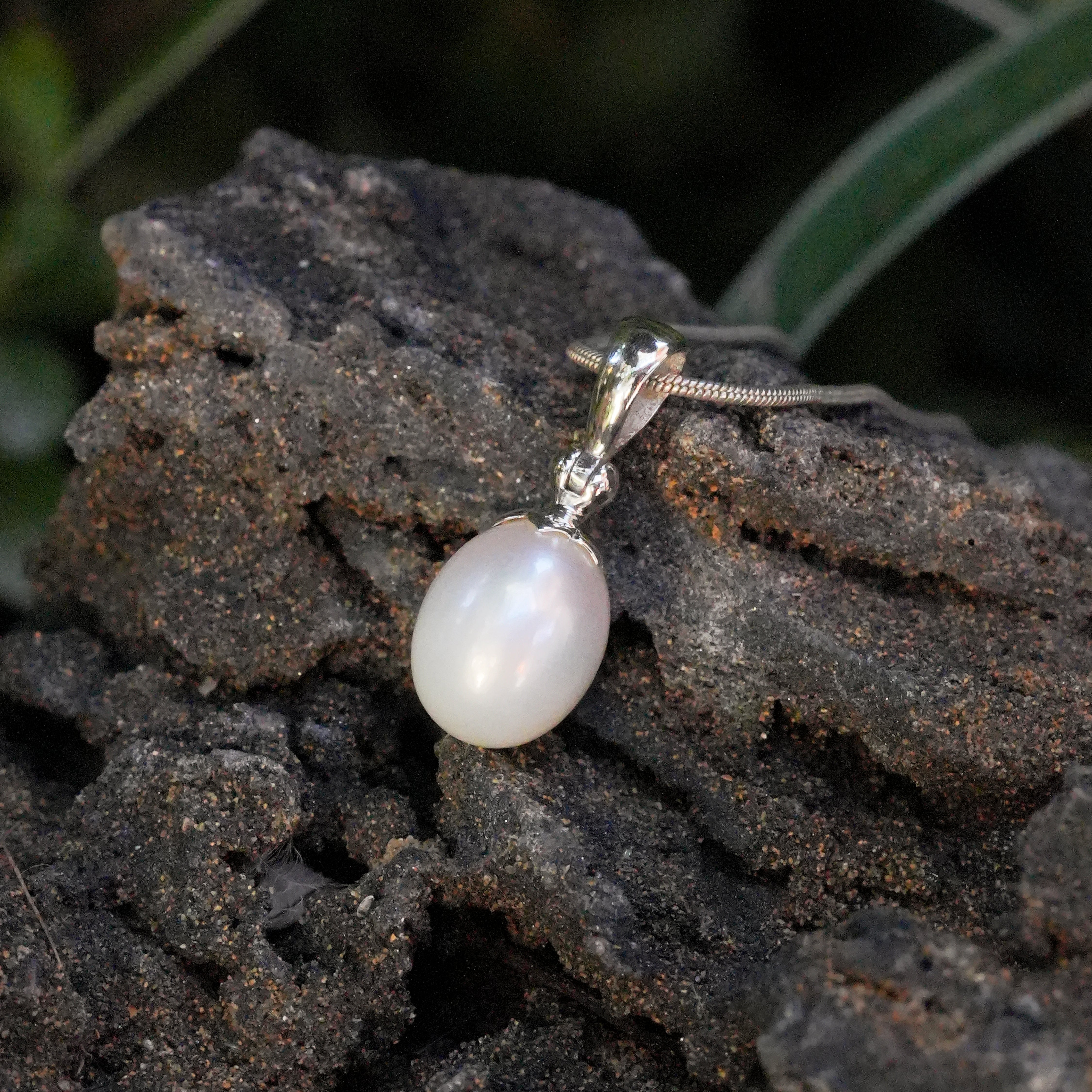 Angled view of the pearl pendant highlighting the soft luster of the freshwater pearl