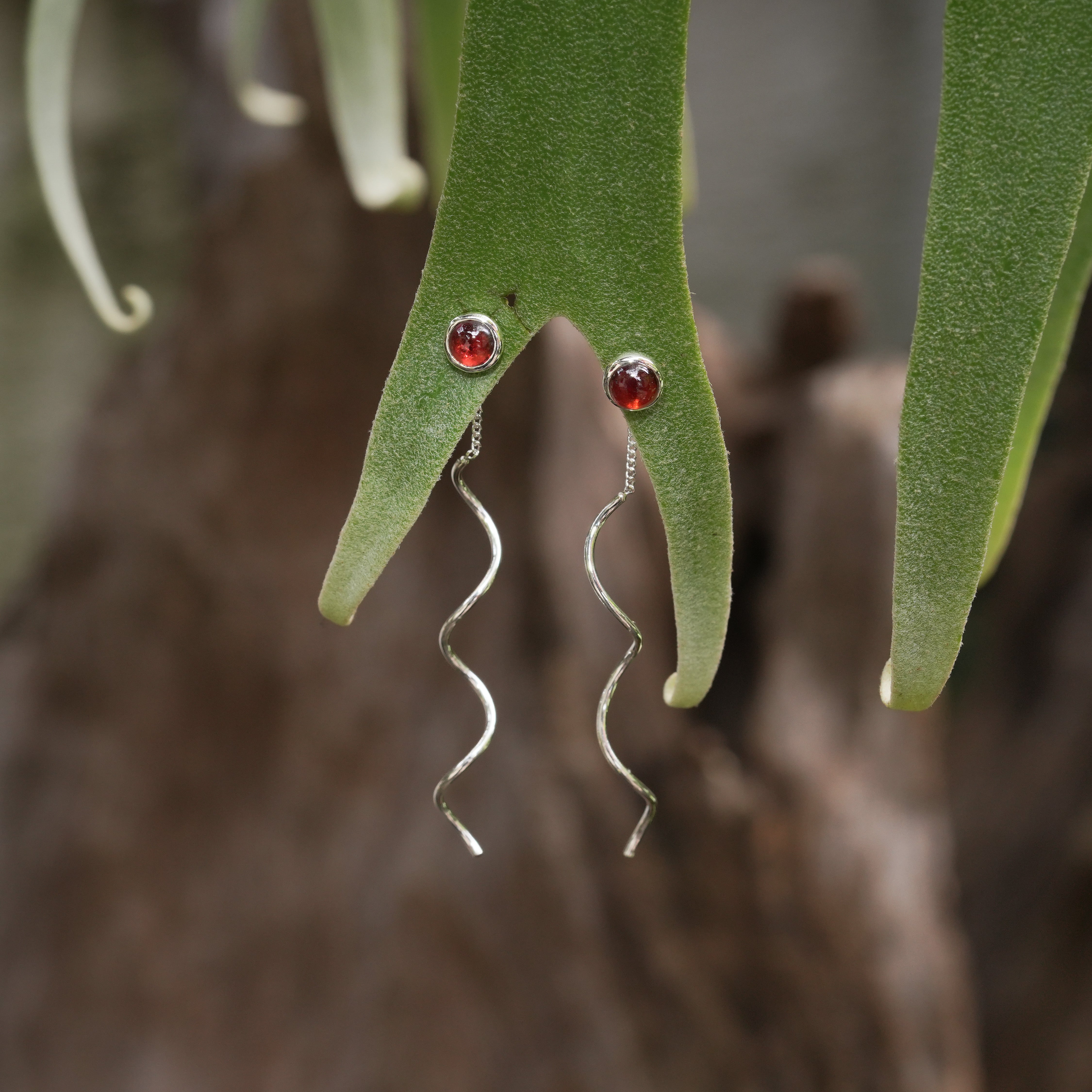 Starborn Polished Garnet Stud Earrings with Flowing Curled Wire Drop in Sterling Silver