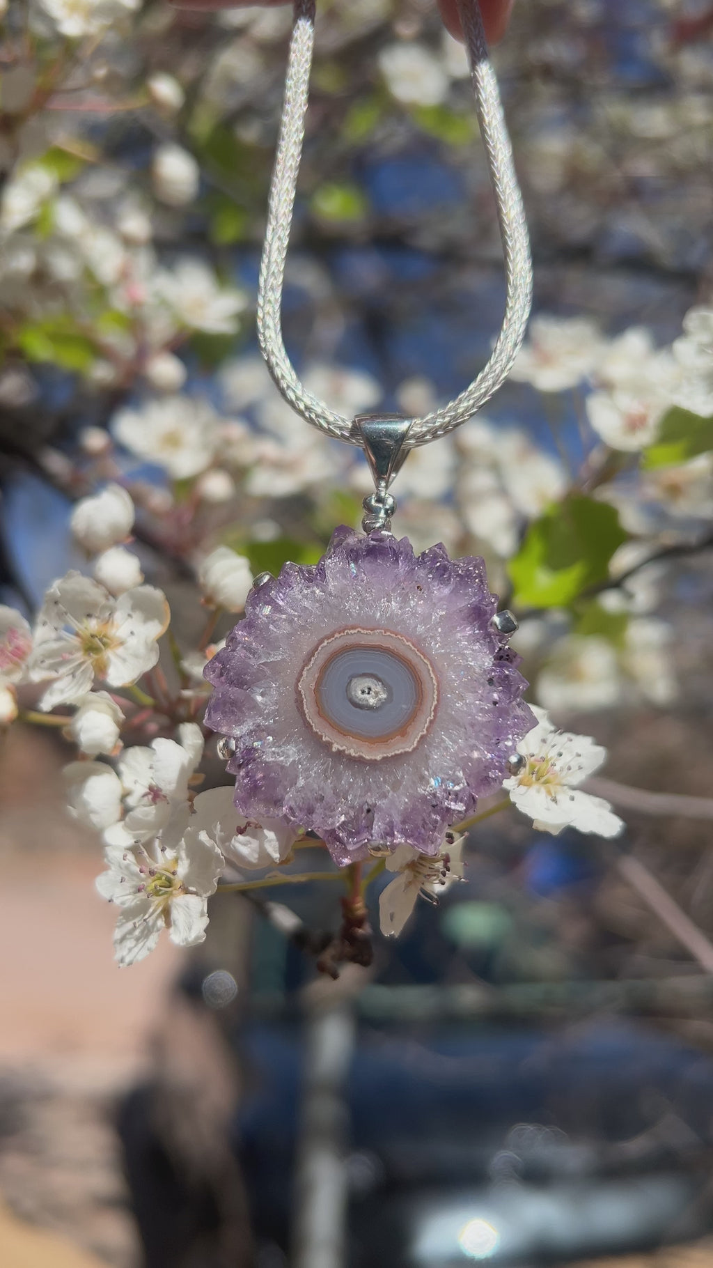 Video showing a close‑up front view of an amethyst rose prong set pendant necklace.