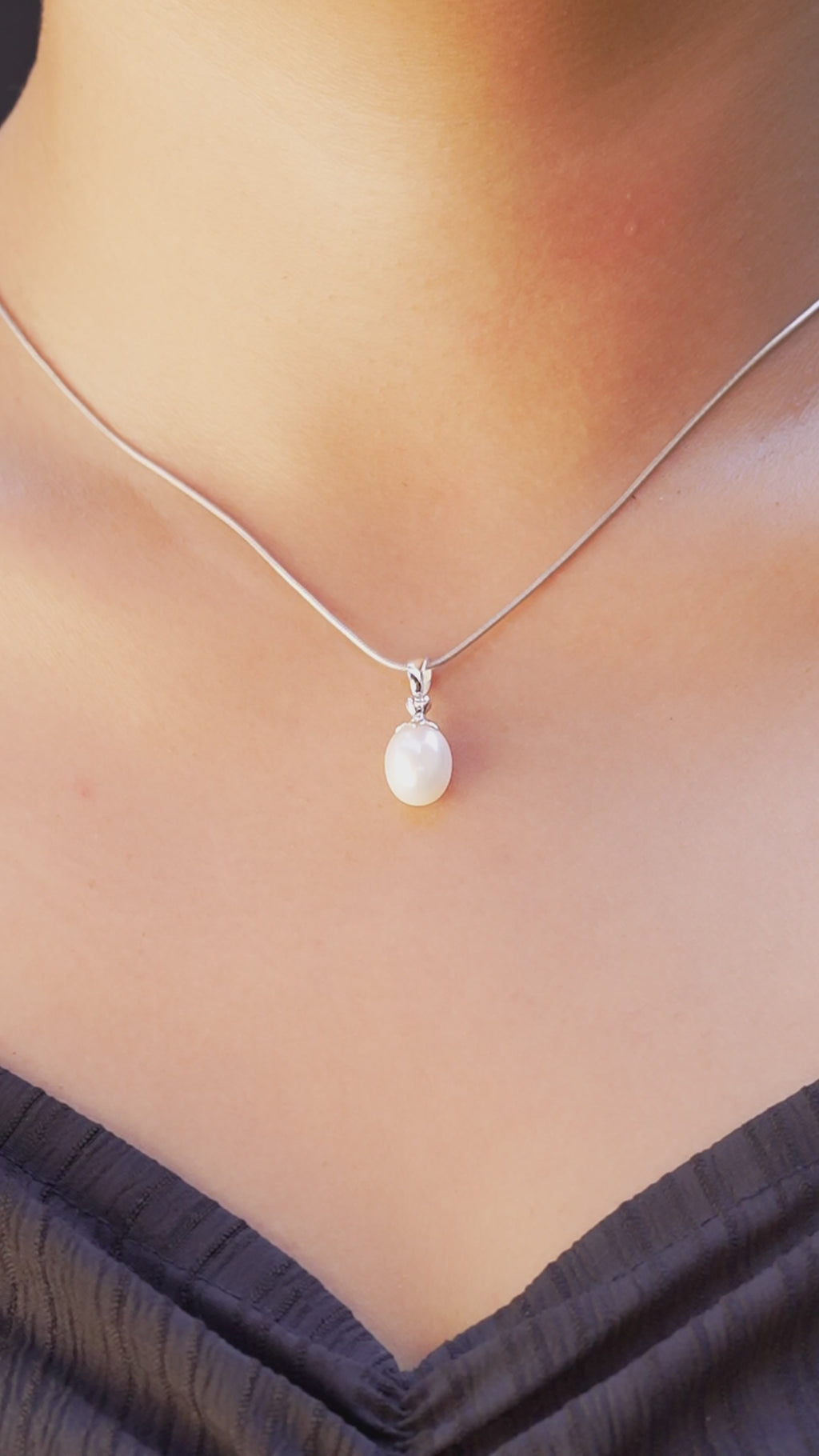 Video showing Freshwater Pearl pendant necklace worn on neckline for size reference