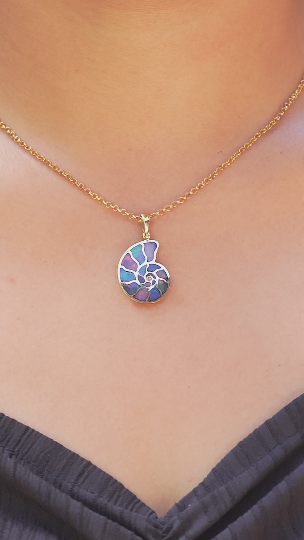 Video of Nordic Nautilus Ammonite with Ethiopian Opal inlay worn on neckline for size reference. 