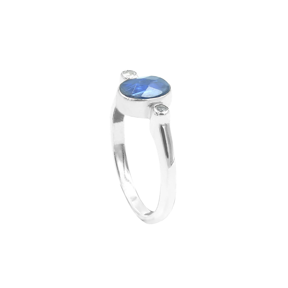 Faceted blue kyanite ring with topaz accents in sterling silver, shown front‑facing with an oval blue faceted kyanite stone set horizontally and a small clear topaz accent on one side of the band.